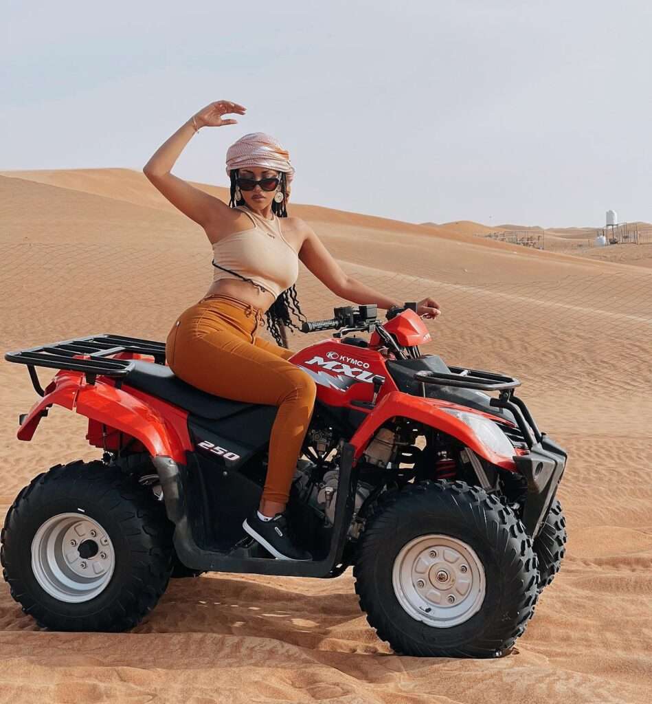 a woman on a quad bike in the desert
